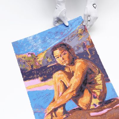 White gloves holding the corner of a colourful print of a swimmer