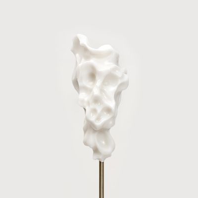white marble sculpture resembling a face on a bronze pole by Kevin Francis Gray