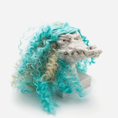 a sculpture of a crocodile head with a custom hair piece in turquoise, Nathalie Djurberg & Hans Berg