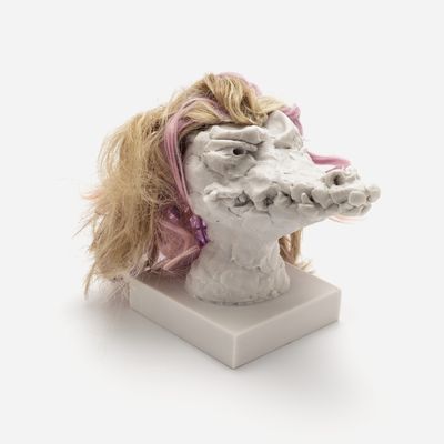 a sculpture of a crocodile head with a custom hair piece in yellow and pink, Nathalie Djurberg & Hans Berg