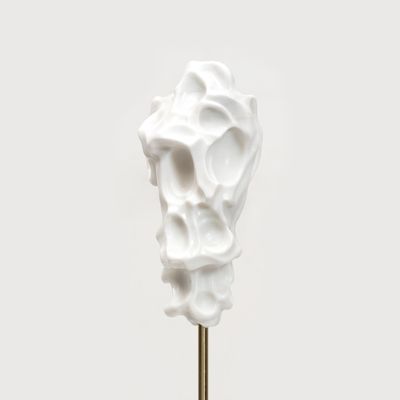 white marble sculpture resembling a face on a bronze pole by Kevin Francis Gray - front close up