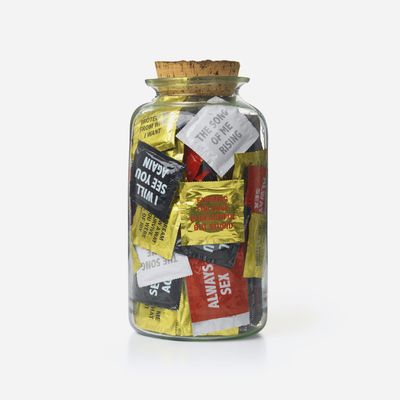 Sculpture of glass jar filled with printed condoms, URGE AND URGE AND URGE by Jenny Holzer