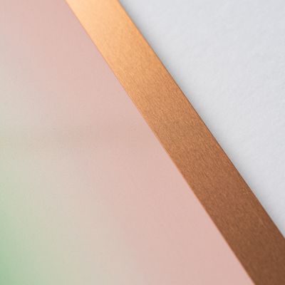 a close-up of a green and pink minimalist print edition by Jonny Niesche in a bronze frame