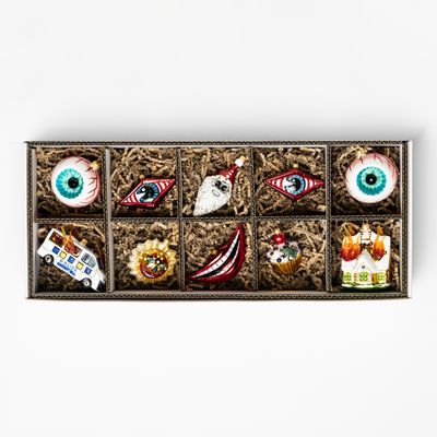 10 glass baubles in 8 different designs in a compartmentalised cardboard box with shredded paper padding