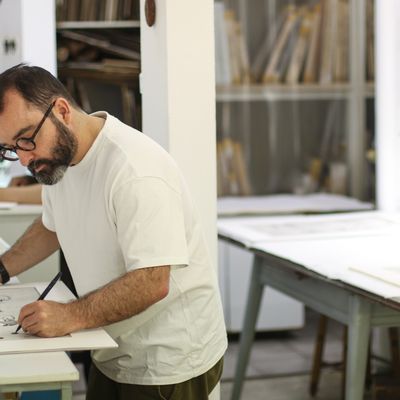 Artist Javier Calleja hand-finishing his prints at the printing house