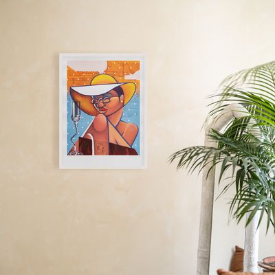 a white framed print hung on a bare wall with a plant and leather sofa next to it