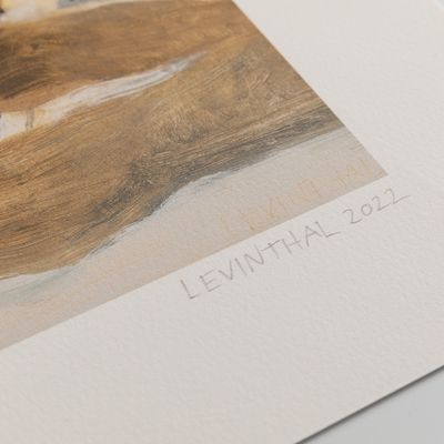 hand signing corner of print - levinthal 2022