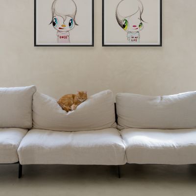 Javier Calleja prints on wall above sofa