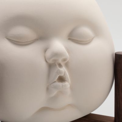 up close of ceramic pot in form of babies face