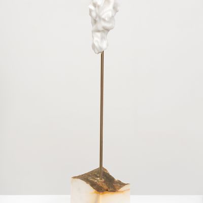white marble sculpture in an organic shape on a bronze pole by Kevin Francis Gray - side view