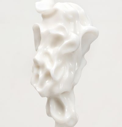 white marble sculpture resembling a face on a bronze pole by Kevin Francis Gray - close up