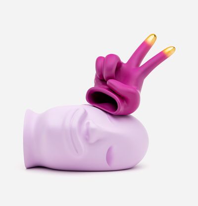 resting pink head with gold tipped peace sign glove resting above