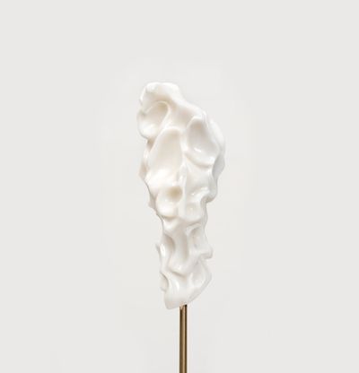 white marble sculpture resembling a face on a bronze pole by Kevin Francis Gray - close up front