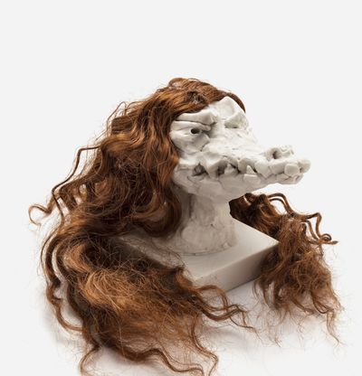 a sculpture of a crocodile head with a custom hair piece in dark brown, Nathalie Djurberg & Hans Berg