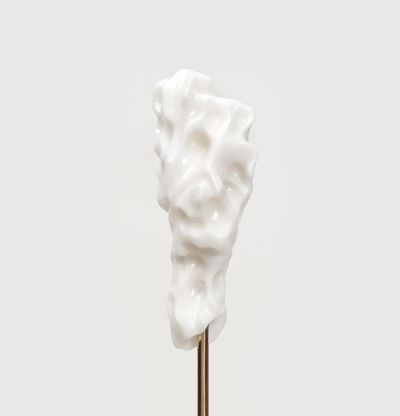 white marble sculpture in an organic shape on a bronze pole by Kevin Francis Gray
