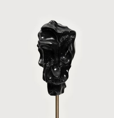 black marble sculpture on a steel stick by Kevin Francis Gray
