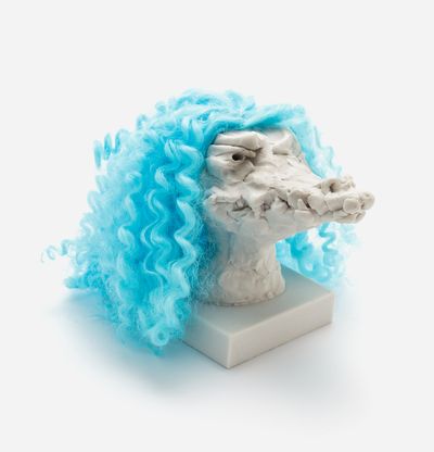 a sculpture of a crocodile head with a custom hair piece in electric blue, Nathalie Djurberg & Hans Berg