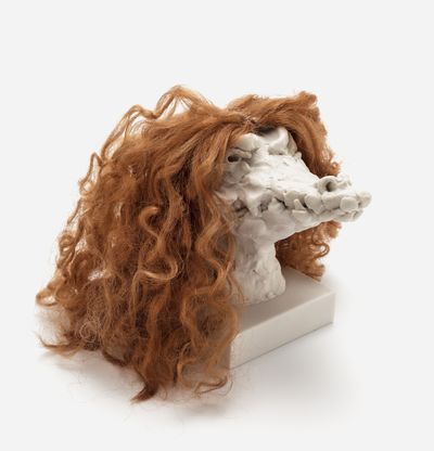 a sculpture of a crocodile head with a custom hair piece in dark ginger, Nathalie Djurberg & Hans Berg
