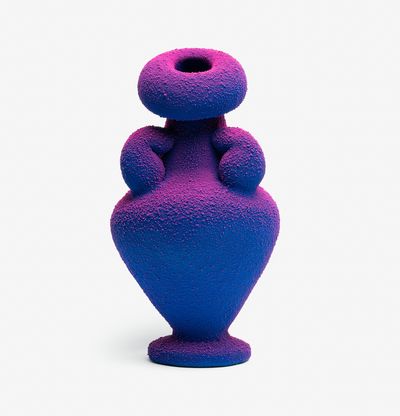 a large sculpted amphora painted in a vibrant blue with pink hues