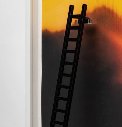 A close-up of a sunset painting with a three-dimensional ladder leading up to the centre