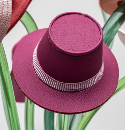 Striped glass vase with pink hat detail