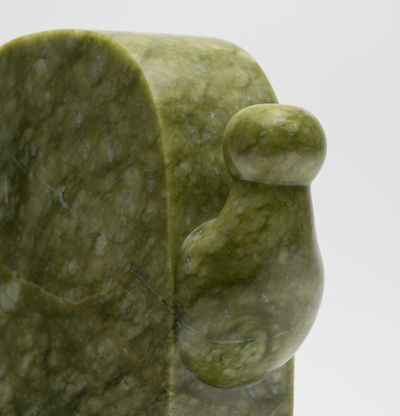 a close-up of a green marble sculpture rendition of Haroshi's endearing character
