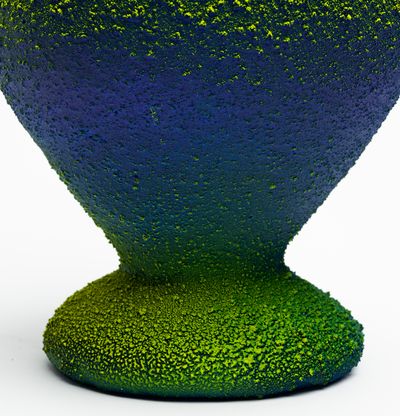 a rounded blue and green ombre amphora with two curved handles