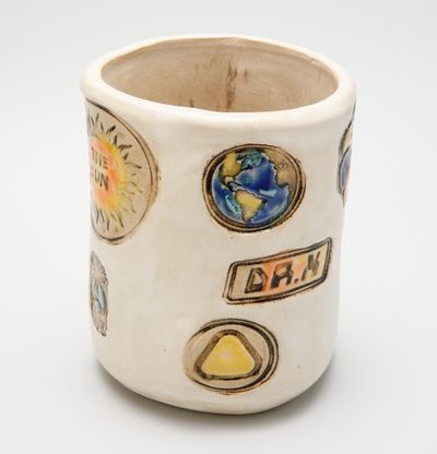 glazed ceramic pot stamped with planet earth and 'the sun'