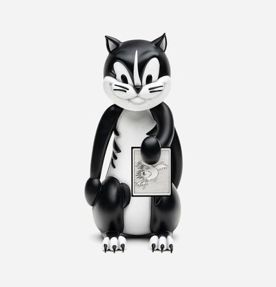 devilish black and white cat sculpture looking at camera