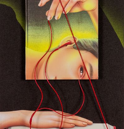 3d book above canvas, girl looks at book whilst listening through headphones with 3d wires