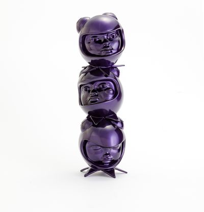 a purple sculpture of three heads in custom helmets stacked on top of each other