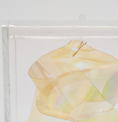 A detail of a mylar light knot housed in a perspex box by artist Larry Bell
