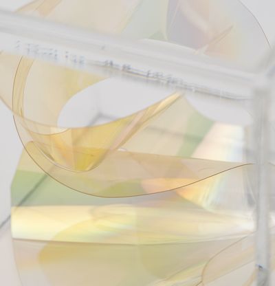 A detail of a mylar light knot housed in a perspex box by artist Larry Bell
