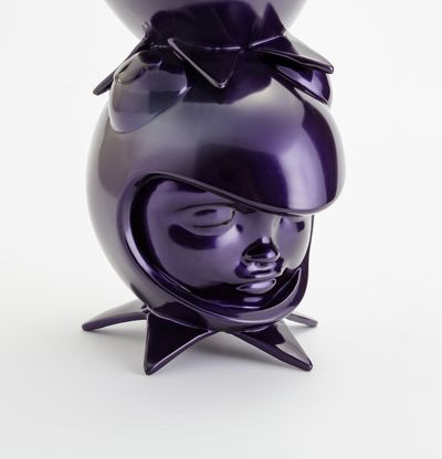 a purple sculpture of three heads in custom helmets stacked on top of each other by Hebru Brantley - close up bottom