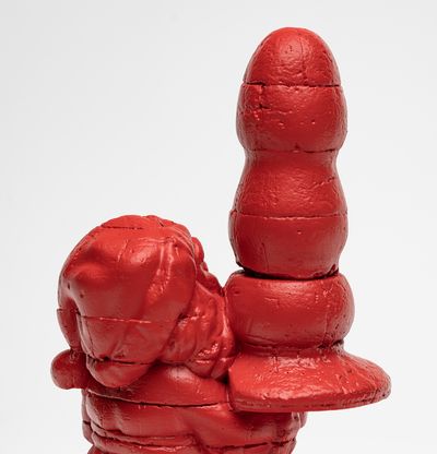 red bronze Santa holding a giant butt plug