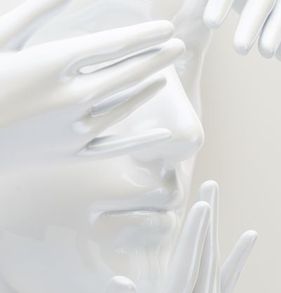 a close-up of a white gloss sculpture of a face emerging from a circular backboard