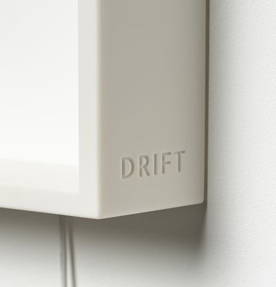 'DRIFT' signature embossed in lower right outside corner of white resin frame