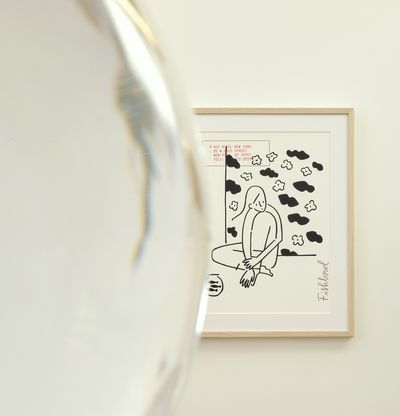 framed print, partially-obscured by a round fishbowl