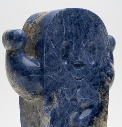 a detail of a blue marble sculpture by artist Haroshi of his recurring character