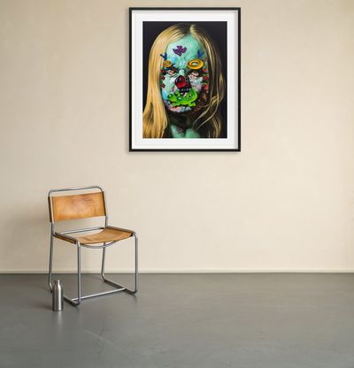framed print hanging next to a leather and steel chair on an off-white wall
