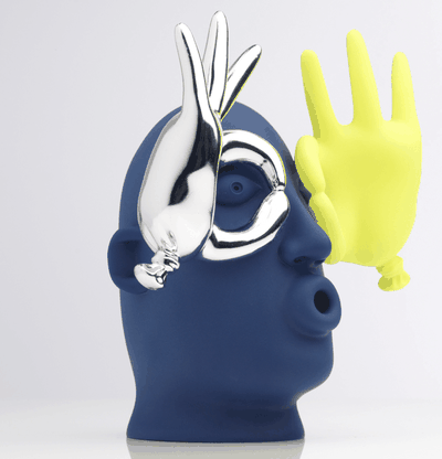 vinyl sculpture of an expressive cartoon face with yellow and silver hands – side view