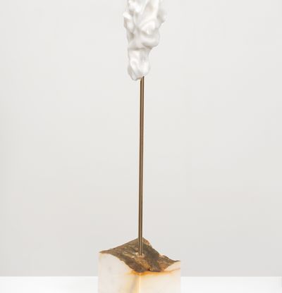 white marble sculpture in an organic shape on a bronze pole by Kevin Francis Gray - side view
