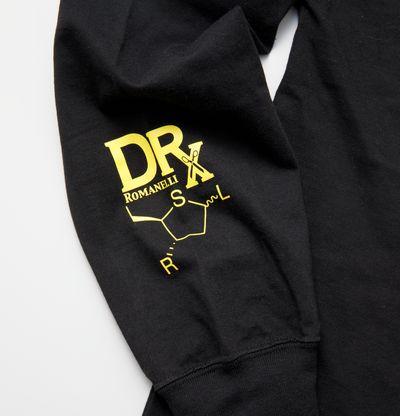 bright yellow logos printed on sleeve of black long sleeve T-Shirt, reading 'DRX' and 'SRL'