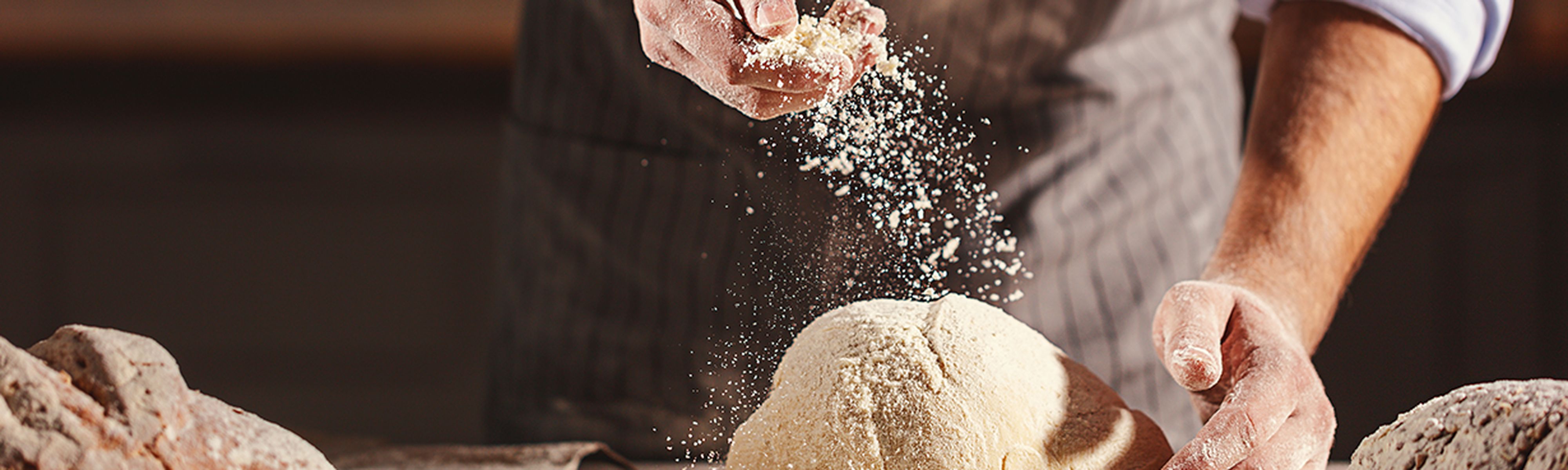 man making bread with flour