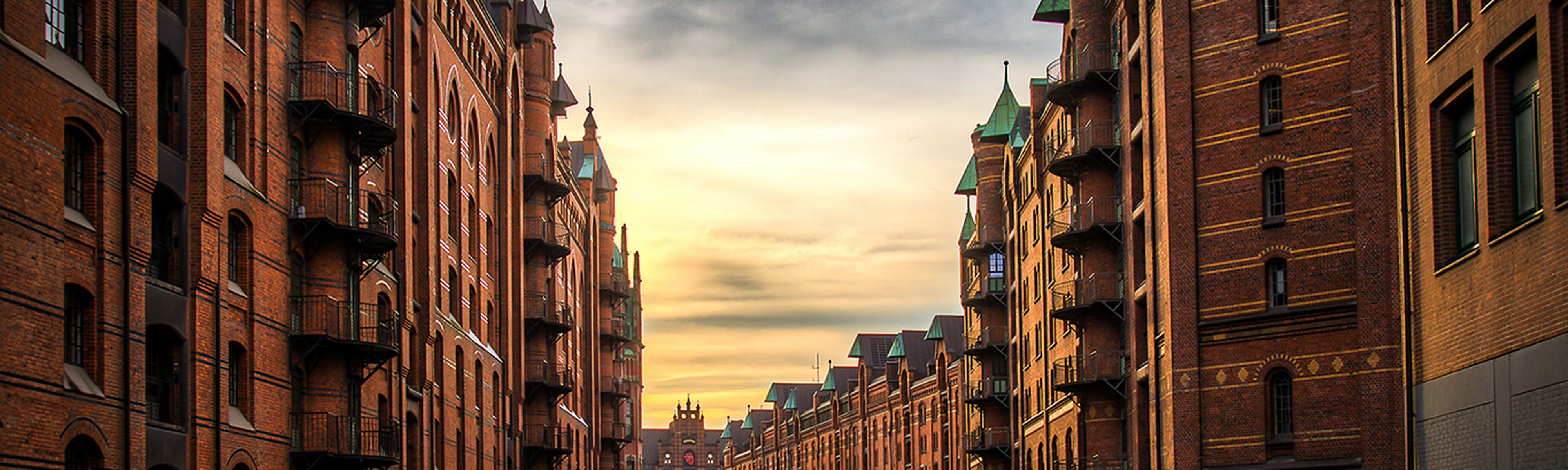 buildings surrounding the river in hamburg germany at sunset