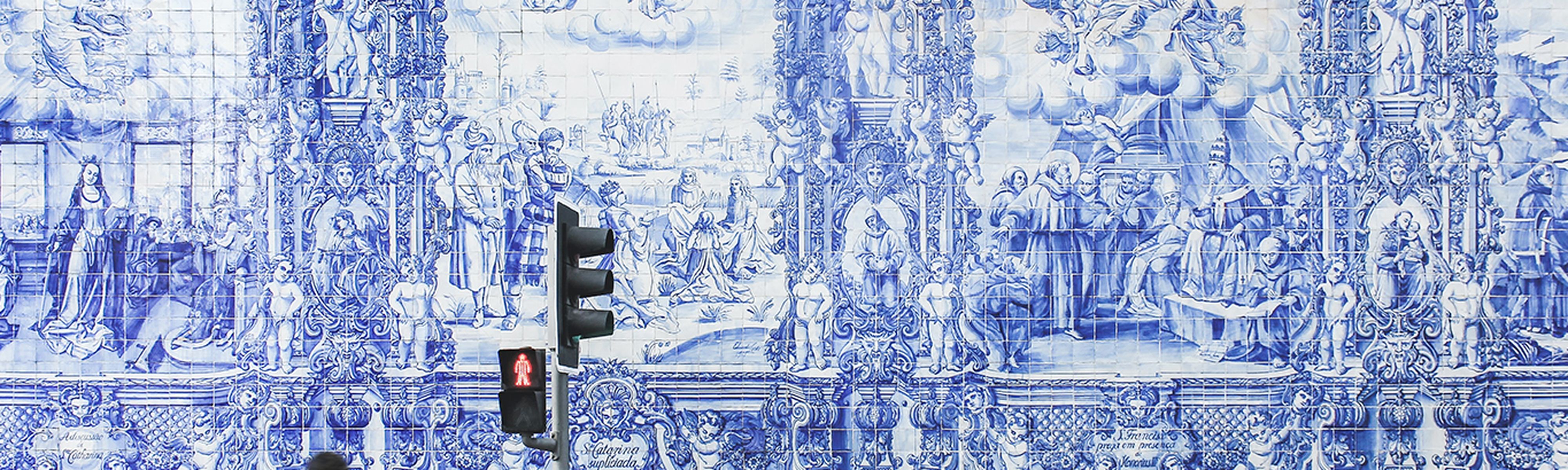 blue and white mosaics on a wall in porto portugal