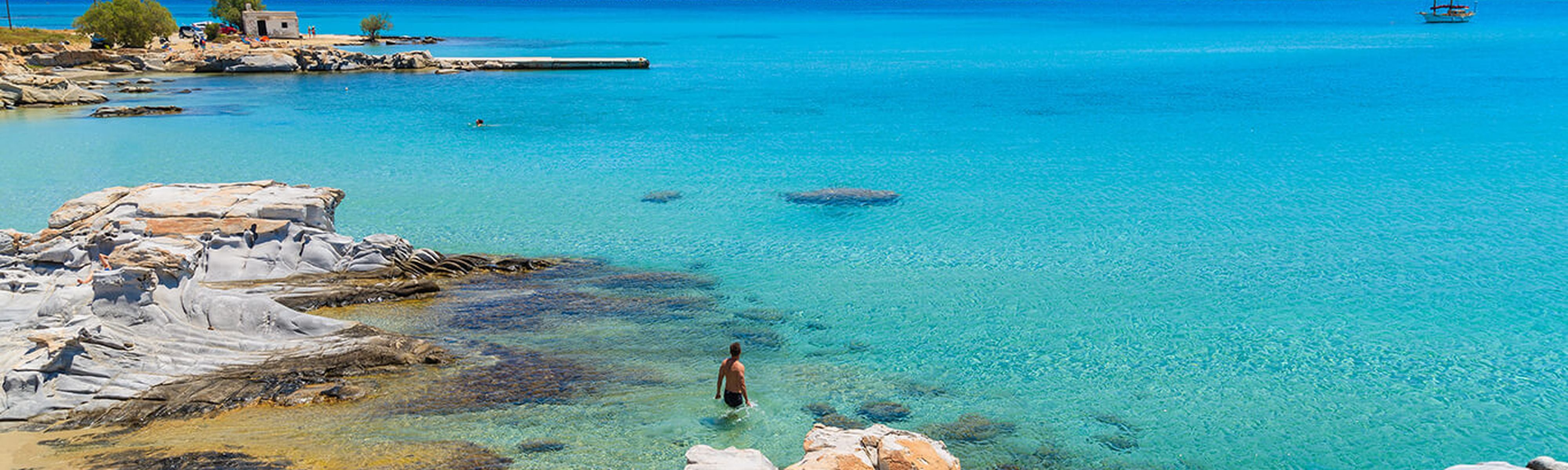 clear blue ocean water along the beach in paros greece