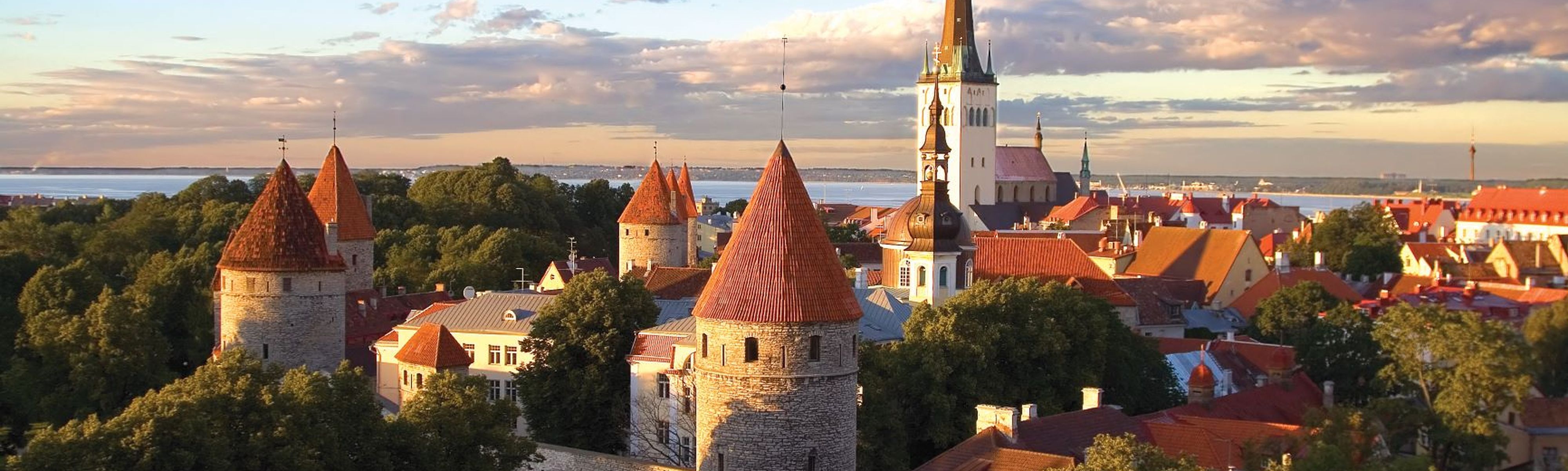 ancient cathedral surrounded by red roof buildings in tallinn estonia at sunset