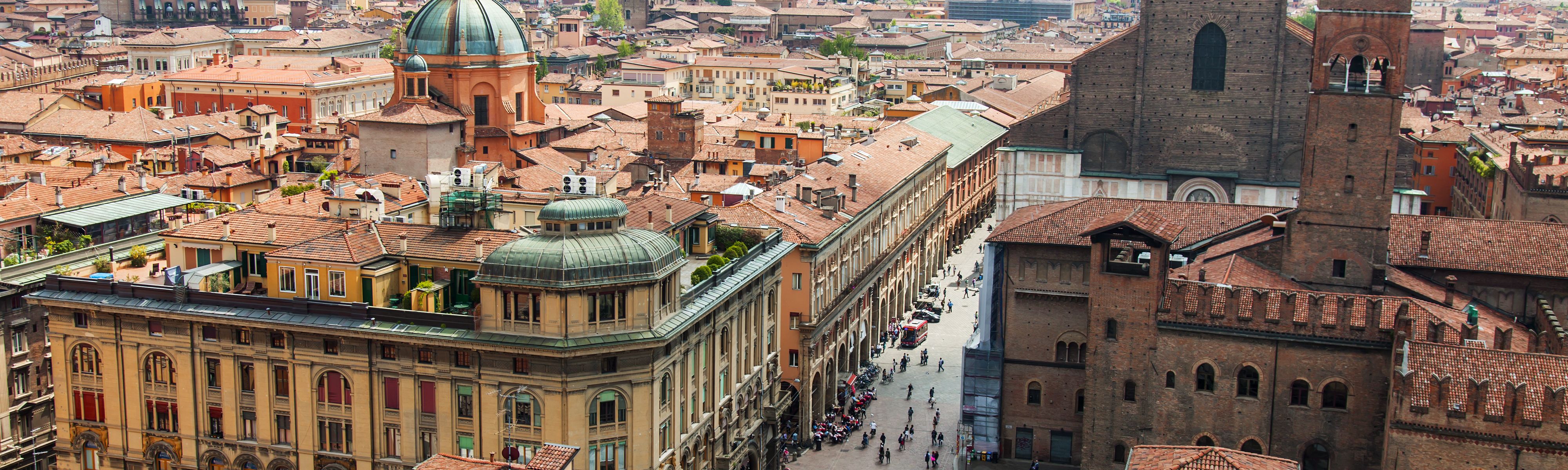 looking down at people walking on streets of bologna in italy