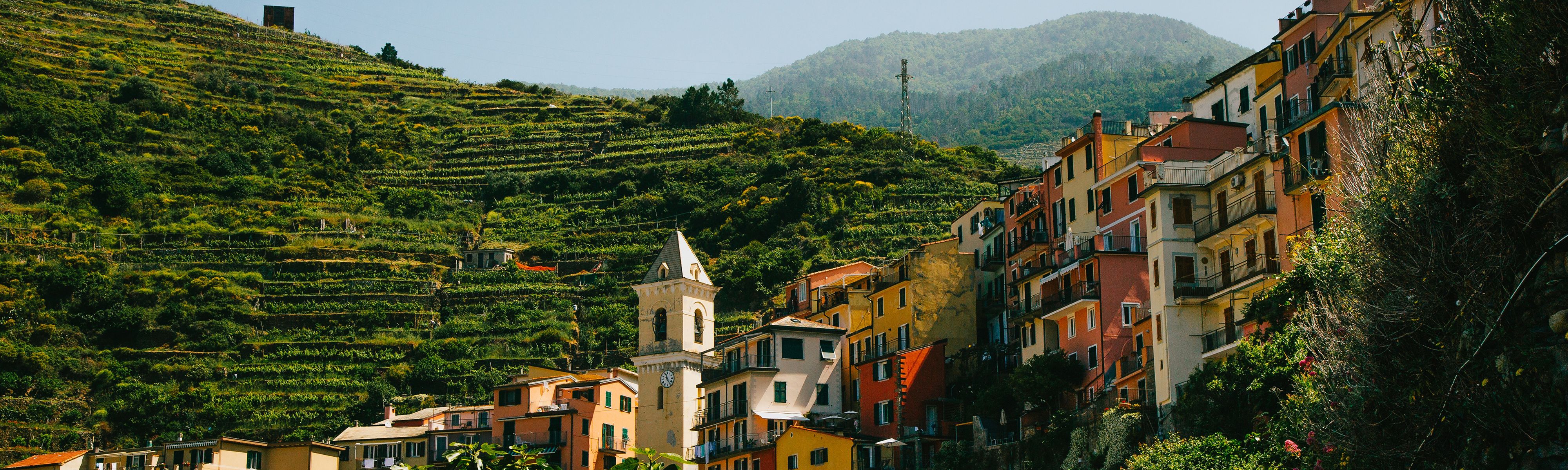 red and tan buildings along the cliffs in cinque terre italy